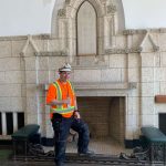 Worker posing with Centre Block Architecture